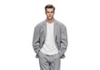© sujon1638 - Fashionable young male model wearing a stylish light gray suit and white t shirt standing confidently isolated on transparent background