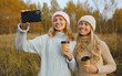 © rohappy - Modern happy women friends taking selfie with phone in park, girlfriends having fun together