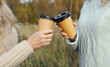 © rohappy - Close up of female hands holding cups of hot coffee drink outdoors