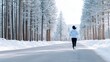© Дмитрий Баронин - Female jogger in a light blue hoodie runs along a snowy road surrounded by tall evergreen trees, showcasing winter fitness and the beauty of nature's tranquility