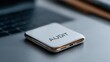 © FocusFusion - Smartphone Displaying the Word Audit in a Modern Workspace Setting