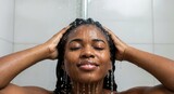Black woman washing her hair in the shower. African american female enjoying her daily hygiene routine. Self-care and beauty concept