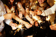 © New Africa - Happy New Year 2026 greeting card. Friends celebrating with sparklers and wine glasses, closeup