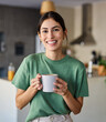 © Lumos sp - Portrait of a young woman drinkng coffee in kitchen