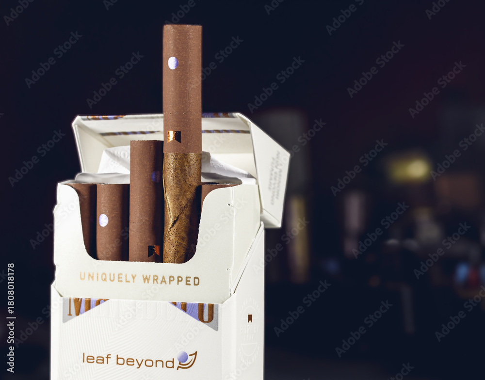 marlboro tobacco leaf wrapped pack of 10 Marlboro leaf beyond uniquely wrapped cigarillos,on dark  background,illustrative editorial. Stock Photo