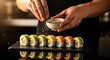© Brother Stocks - Close-up culinary creation: Skilled hands delicately garnishing vibrant sushi rolls on reflective surface for an