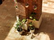 © agung - Home interior decoration with flowering plants in pots mounted on a vintage brick pillar. Cozy, bright space with natural light and shadow play.