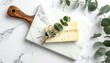 © Almarkha - Cheese block, eucalyptus on marble board