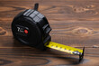 © eliosdnepr - Black tape measure on wooden background