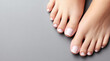 © Victoria - Woman's feet displaying a fresh french pedicure, symbolizing beauty, hygiene, and self-care practices in a clean and minimal background with copy space, highlighting well-groomed toes and healthy skin