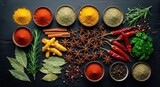 Colorful array of aromatic spices and herbs on dark wooden surface.