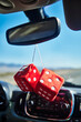 © Michael Marquand - red fuzzy dice hanging off the rear view mirror