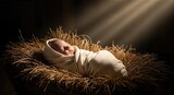 The sleeping infant Jesus, wrapped in white cloth and lying in a wooden manger filled with hay, is illuminated by a single, powerful beam of light, emphasizing the sanctity of the Christmas night