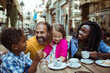 © Davor - Happy adult parents with children enjoying dessert at outdoor cafe