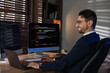 © New Africa - Programmer in glasses working on laptop at table in office