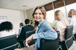 © deagreez - Young businesswoman attending a professional development conference with a team of professionals in an office setting