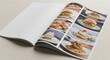 © MindRender - Open magazine or menu mockup displaying vibrant food images on one page, with a blank page for custom content