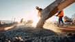 © dinatychynska - Workers pouring fresh concrete from shovel at construction site with sunlight. Cement mixture flowing onto foundation with motion. Building infrastructure development project, professional teamwork.