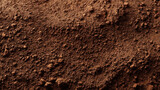 Rich brown clay surface with fine grain texture, earthy natural soil close up
