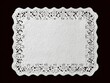 © MakeStories.com - White rectangular paper lace doily on dark background