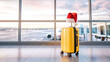 © peppystudio - Yellow suitcase with Santa hat at airport terminal during holiday season
