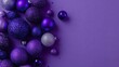 © Oleh - Assorted sizes and textures of sparkling purple and silver christmas baubles are arranged on a uniform purple background, creating a festive decorative border with ample copy space