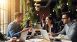 © ViskBx - Business team collaborating at a table with laptops in a bright and modern office space setting indoors