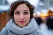 © Florian Dussart - Portrait of smiling young woman wearing grey scarf in snowy winter street