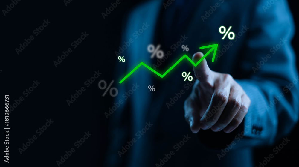 A businessman pointing at a glowing upward trend line with percentage ...