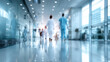 © narumon - Blurred image of medical personnel walking confidently in corridor of modern hospital. Medical teamwork concept.