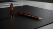© ip - A maroon fountain pen with gold accents resting on a dark gray desk mat. Elegant writing instrument on a modern office workspace.