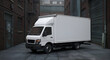 © ip - White delivery van parked in urban alleyway. Stationary vehicle with blank advertising space, urban setting. Delivery driver in city commercial district -
