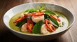 © FARVEZ - Delicious thai green curry with shrimp red pepper and basil leaves a traditional asian food recipe served steaming hot in a white bowl
