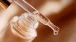 © fotofabrika - Close-up of a dropper releasing skincare serum from a glass bottle