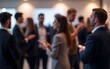 © li - Networking Event Attendees Blurred - People networking at an event, with the background blurred to emphasize the interactions. High quality