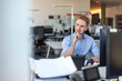 © Westend61 - Thoughtful business employee at desk in modern office environment