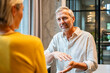 © Westend61 - Mature colleagues having a business discussion in office setting
