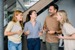 © Westend61 - Business team laughing and having conversation in modern office
