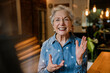 © Westend61 - Entrepreneur in denim shirt smiling confidently in cafe workspace