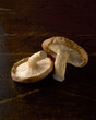 © Westend61 - Two shiitake mushrooms on rustic wooden surface