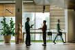 © Westend61 - Colleagues discussing in modern office interior with city view