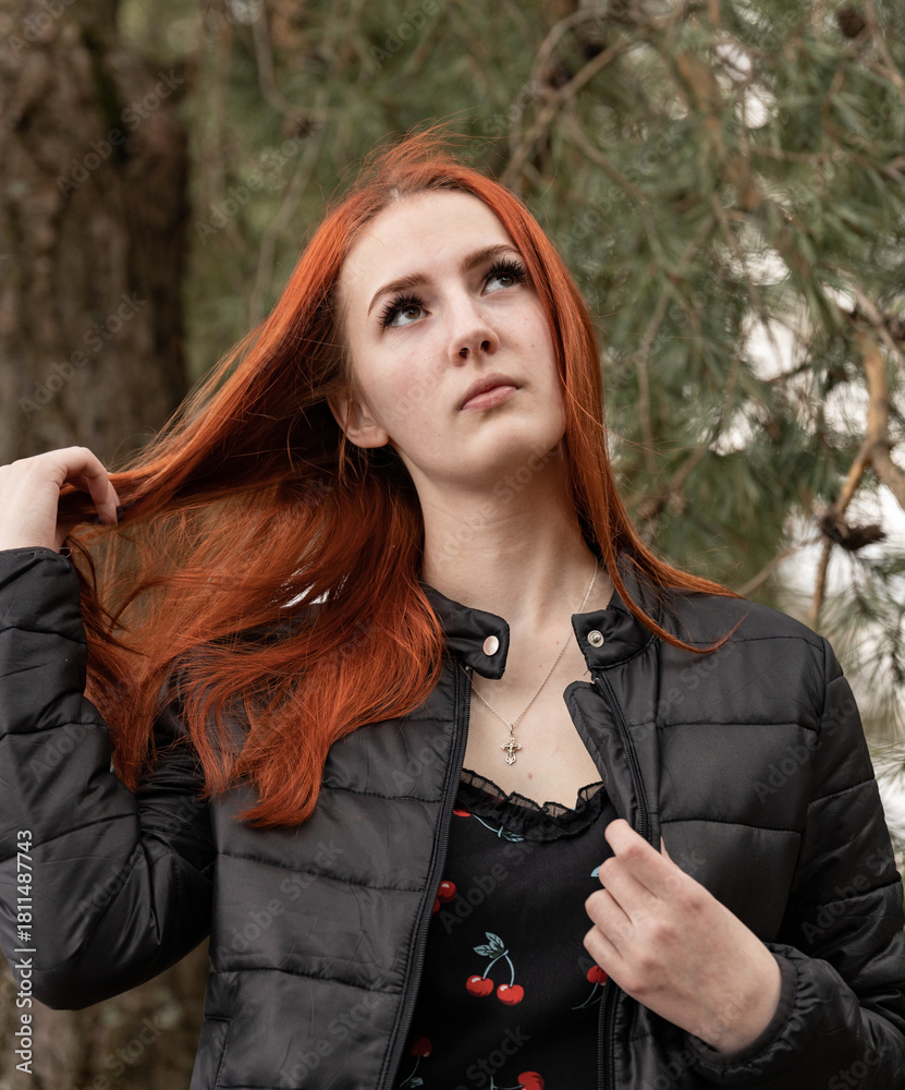 Woman with red hair is wearing a black jacket and a necklace Stock ...
