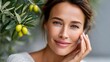 © Lubos Chlubny - Woman smiling with olive branch, natural beauty concept