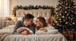 © Vasiliy - Happy young couple lying on bed in cozy Christmas bedroom. Romantic man and woman looking at each other near decorated tree. Winter holiday lifestyle