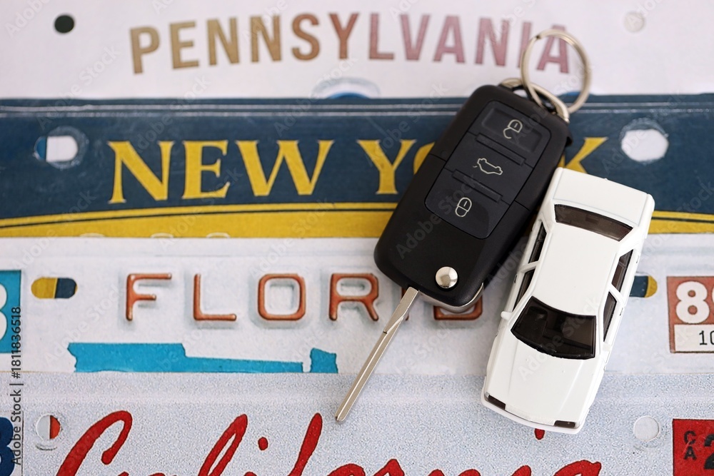 Remote control car keys on US license plates with state names close up ...