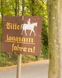 © Ulrich - Road sign showing horse rider and asking drivers to slow down in german
