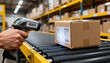 © Netsai - Warehouse worker scanning a package on a conveyor belt with a handheld barcode reader, focusing on logistics and inventory management tasks.