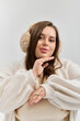© Bliss - Young woman enjoys a cozy moment in a winter setting while showcasing her fashion style