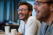 © Mind - Happy man candid smile glasses beard casual shirt office coworker teamwork