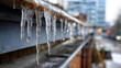 © Kateryna - Hazardous elongated ice formations icicles on building edge faceless danger scene defocused roof background winter property hazard frozen water accumulation seasonal safety